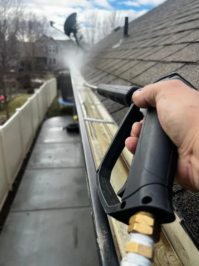 Gutter cleaning in Kelowna, roof gutter being rinsed clean